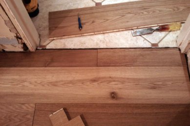 Floor boards laid perfectly at the doorway ready for architraves, skirting and threshold
