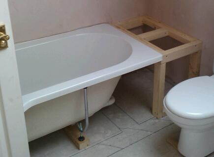 Build a solid DIY timber frame work to support the edge of the bathtub and fix the new bath panels to